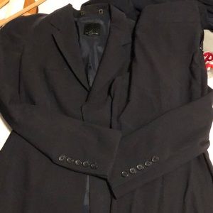 Black pant suit that has blue lines.